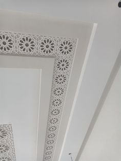 the ceiling is decorated with intricate white paper