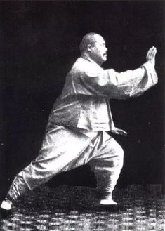 an old black and white photo of a man in karate stance