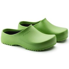 a pair of green clogs sitting on top of each other