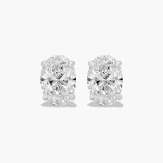 These classic oval-shaped diamond earrings are a timeless and elegant addition to any jewelry collection. The tapered basket setting showcases the unique beauty of the oval-shaped diamonds, which sparkle and shimmer with every move. The earrings are made of high-quality platinum, which is a durable and precious metal that will stand the test of time. Each earring features a single oval-shaped diamond that weighs approximately 1.00 carats in total. The diamonds are near-colorless (H-I color grade Formal Gia Certified Oval Earrings, Elegant Gia Certified Oval Diamond Earrings, Luxury Gia Certified Oval Diamond Earrings, Luxury Oval Diamond White Diamond Earrings, Gia Certified Oval Diamond Earrings, Luxury Oval Diamond Earrings For Formal Events, Luxury Oval Diamond Earrings For Formal Occasions, Luxury Oval Brilliant Cut Earrings, Vvs Clarity Oval Diamond Earrings