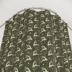 a curtain with deers and trees on it