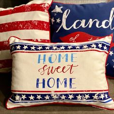 three patriotic pillows on a couch with the words home sweet home written in red, white and blue