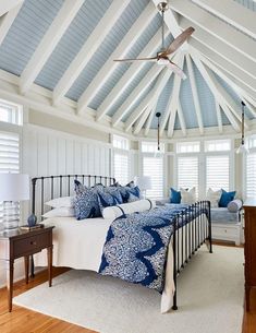 a bedroom with white walls and blue accents