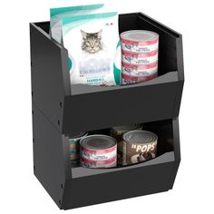 an open black box with canned food and cat food in it's bottom compartment