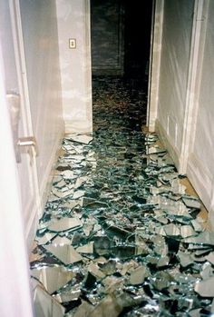 a hallway with broken glass on the floor