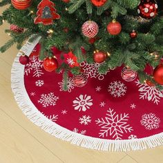 a christmas tree skirt with ornaments on it