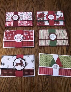 four christmas cards laid out on a table