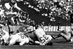 the football players are playing against each other on the field in front of an audience