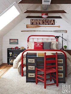 a bedroom with a bed, desk and dressers in it's attic space