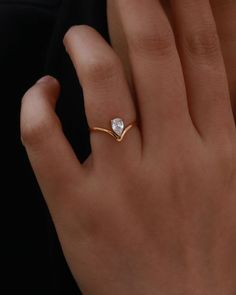 a woman's hand with a diamond ring on it