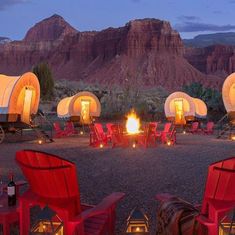 a group of red chairs sitting around a fire pit