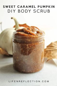 sweet caramel pumpkin diy body scrub in a glass jar with fall leaves around it