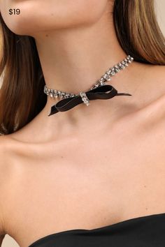 Everyone will be stopping and staring because the Lulus Purest Shine Silver Rhinestone Bow Choker Necklace is positively dazzling! This stunning necklace is composed of silver-toned metal that shapes a choker-inspired silhouette, embellished with sparkling clear rhinestones. A black faux leather bow at the center (with additional rhinestones) completes the eye-catching design. Lobster clasp closure. Necklace Measures 12" Long With A 3" Extender Chain. 40% Brass, 35% Glass, 25% PU. Imported. Lulu Bow Choker, Rhinestone Choker, Rhinestone Bow, Leather Bow, Leather Bows, Accessories Jewelry Necklace, Stunning Necklace, Silver Rhinestone, Clear Rhinestones