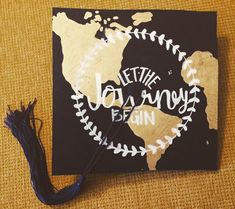 a graduation cap with the words let the journey begin on it and a tassel