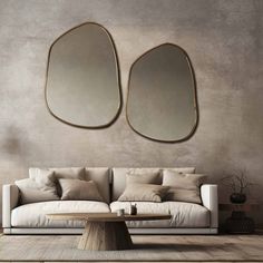 a living room with two mirrors on the wall and a couch in front of it