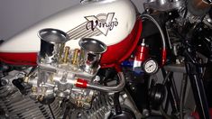 a red and white motorcycle engine sitting on top of a table