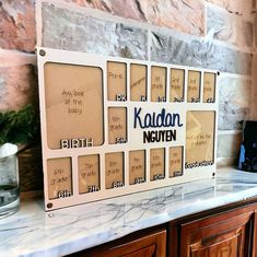 there is a sign on the counter that says kaladaln neuben, and it's in front of a brick wall