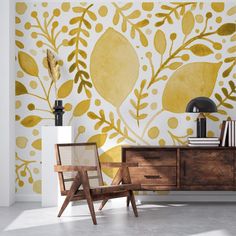 a yellow and white floral wallpaper in a room with two chairs, a lamp and a dresser