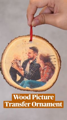 a person holding a piece of wood with the word coaster in front of them on it