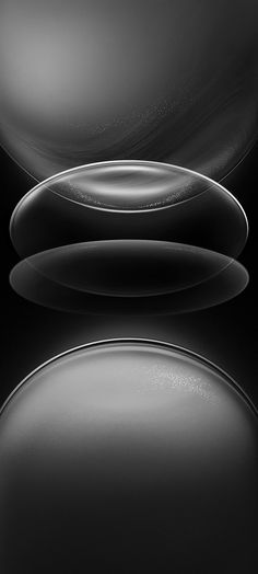 an abstract black and white photo with circles in the middle, on a dark background