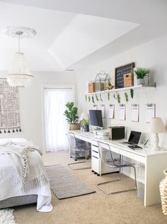 a bedroom with a bed, desk and computer