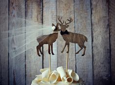 the cake is decorated with two deer on top