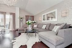 a living room filled with furniture and a chandelier