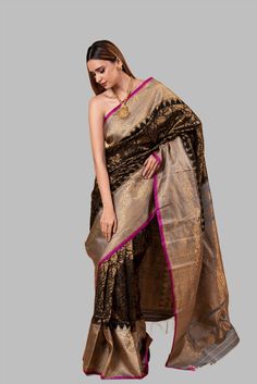 Gadwal Silk Brocade Saree in classic black, exquisitely crafted with a golden zari floral brocade across its expanse. This saree is embellished with a striking broad border of gold zari floral brocade set against a vivid pink edge. The Pallu, splendid with a contrasting gold zari floral brocade pattern, adds to its regal charm. This saree is an impeccable combination of sophistication and contemporary fashion, sure to elevate any wardrobe. Sari For Women, Black Sari, Baluchari Saree, White Embroidered Blouse, Golden Saree, Brocade Pattern, Brocade Saree, Silver Blouse, Orange Saree