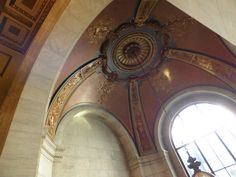 an ornately decorated ceiling and windows in a building