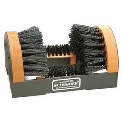 a black brush is sitting in a wooden holder