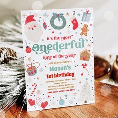 a birthday card sitting on top of a wooden table next to pine cones and christmas decorations