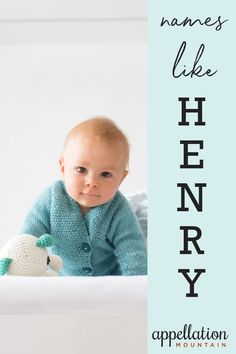 a baby in a blue cardigan is holding a stuffed animal