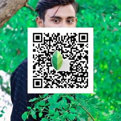 a man is holding up a qr code for an apple logo in front of his face