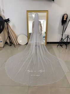 a wedding veil is on display in front of a mirror