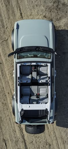 an overhead view of the back end of a truck with its doors open and seats folded down