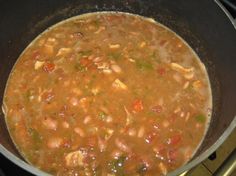 a pot filled with soup sitting on top of a stove