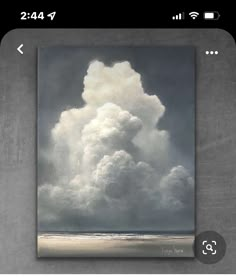 an image of a cloud in the sky over a body of water on a cell phone