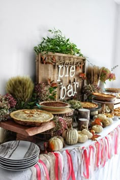 a table topped with lots of pies and plates