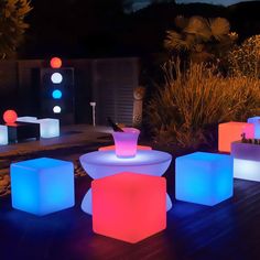 several illuminated stools on a deck at night