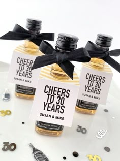 three bottles of cheer's to 30 years on a plate with confetti