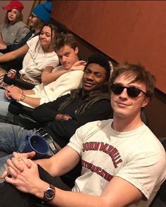 a group of young men sitting next to each other