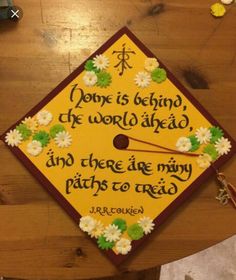 a graduation cap with flowers on it that says, done is being the world ahead and there are many paths to reach