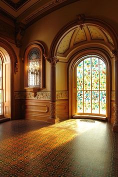 an empty room with stained glass windows and tiled floor