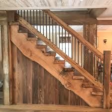 a wooden stair case with metal handrails