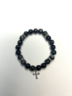 7 inch handmade black and gray beaded bracelet with silver accents, and silver cross pendant. Black Grunge Bracelets As Gift, Silver Cross Jewelry With Black Beads, Adjustable Silver Beaded Cross Bracelets, Black Spiritual Rosary Bracelet With Cross, Black Cross Bracelet, Handmade Black Cross Rosary Bracelet, Christian Outfits, Grey Beads, Black Bracelet