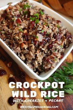 crockpot wild rice with herbs and raisins in a white bowl on a wooden table