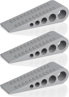 two gray plastic pegs with holes in them