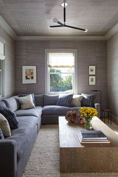 a living room filled with furniture and a flat screen tv mounted to the side of a wall