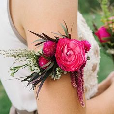 a close up of a person wearing a flower wrist corsage