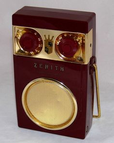 a red and gold radio sitting on top of a white table